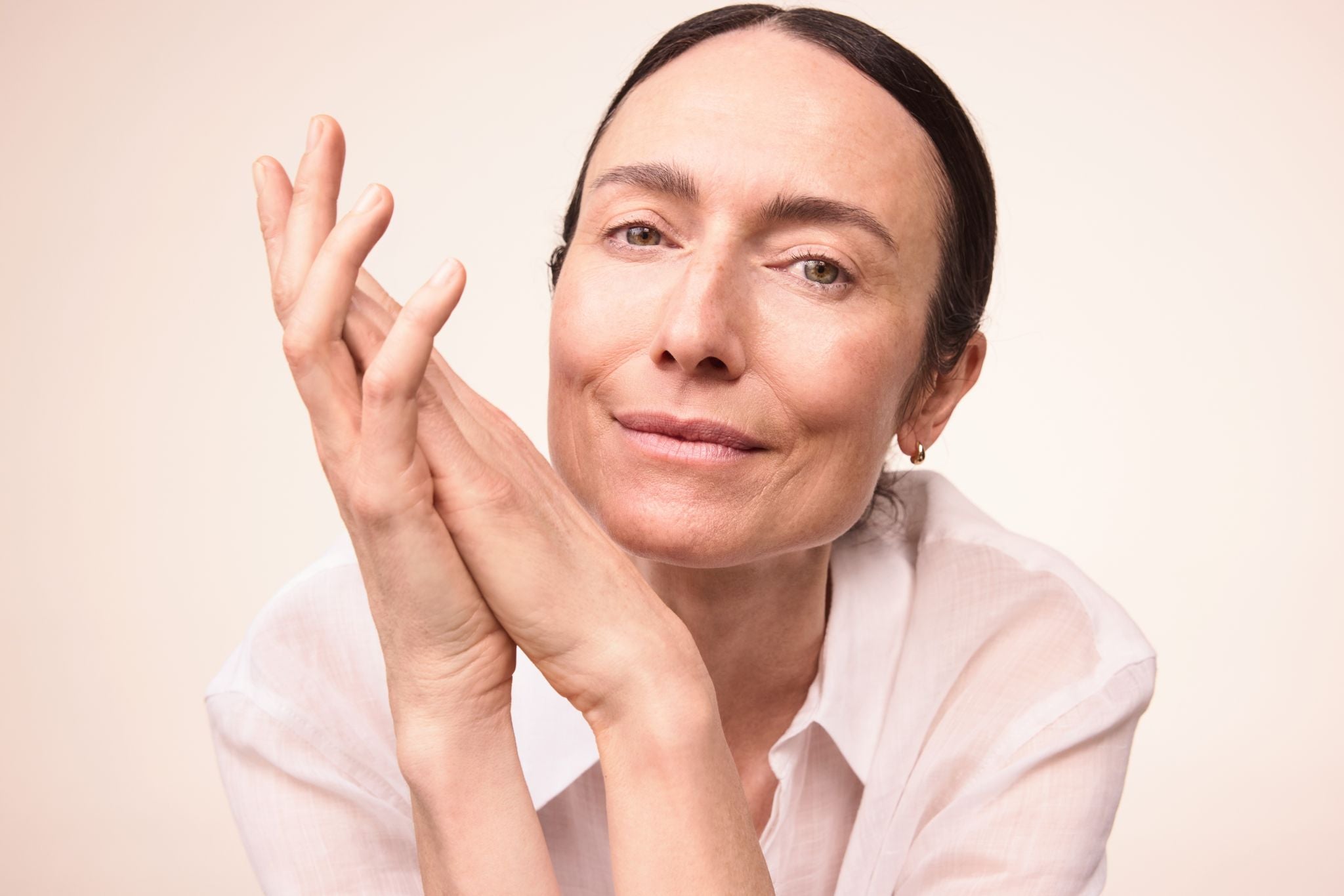 Donna con le mani giunte accanto al viso